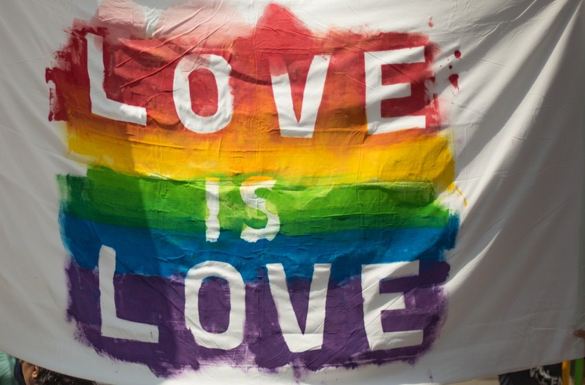 Image of a flag that says love is life referencing LGBTQIA nightlife in NJ