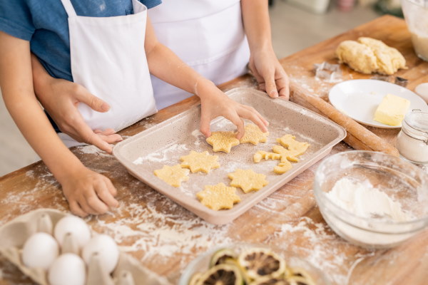 Image of a child and instructor making start shaped biscuits in a cooking class in NJ