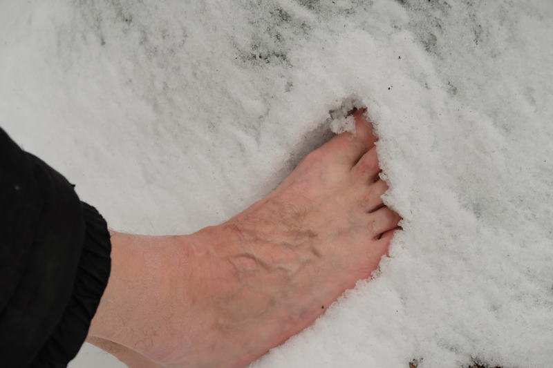 Man walking in the snow in NJ barefoot