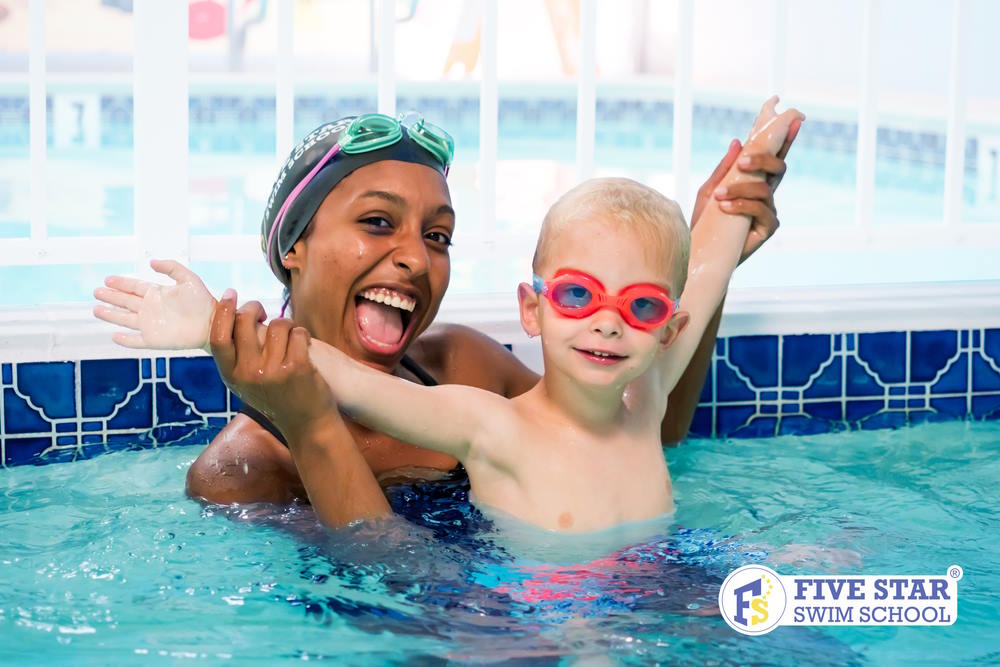 Image of a swimming instructor and a toddler swimming in a pool at the Five Start Swim School in NJ