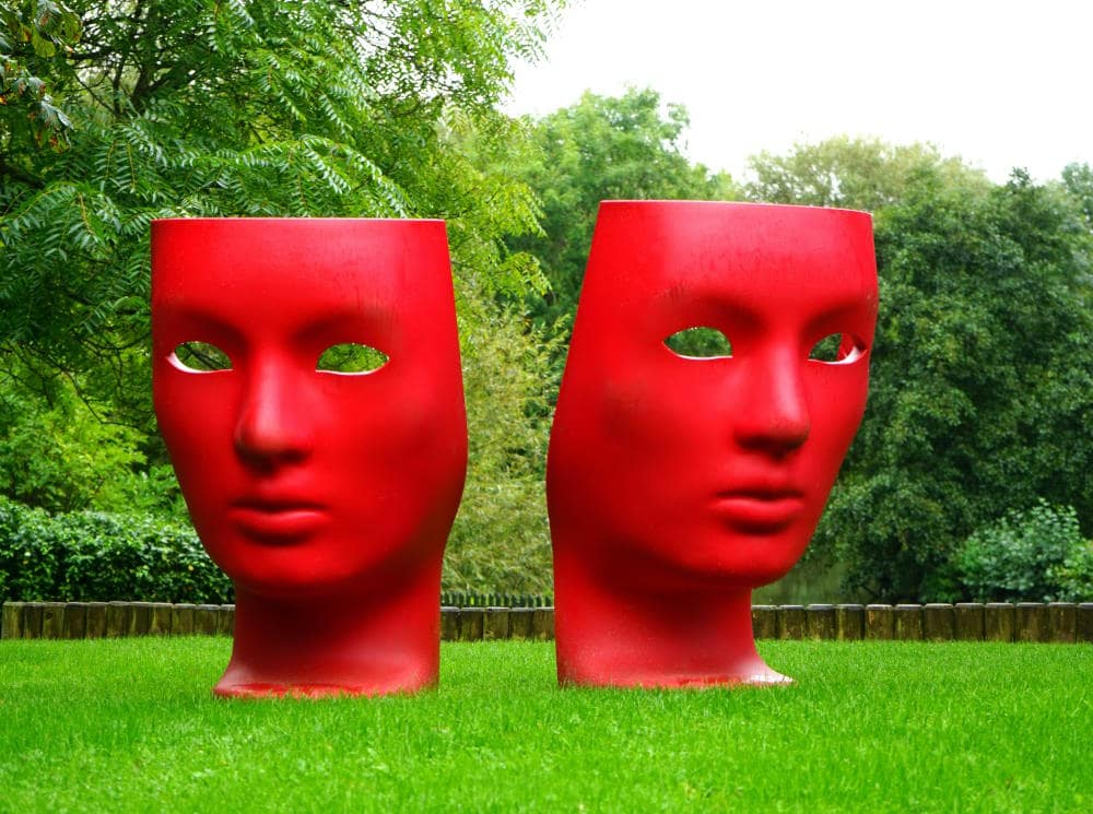 Image of two big ceramic red heads at the Grounds for Scultpture museum in NJ 