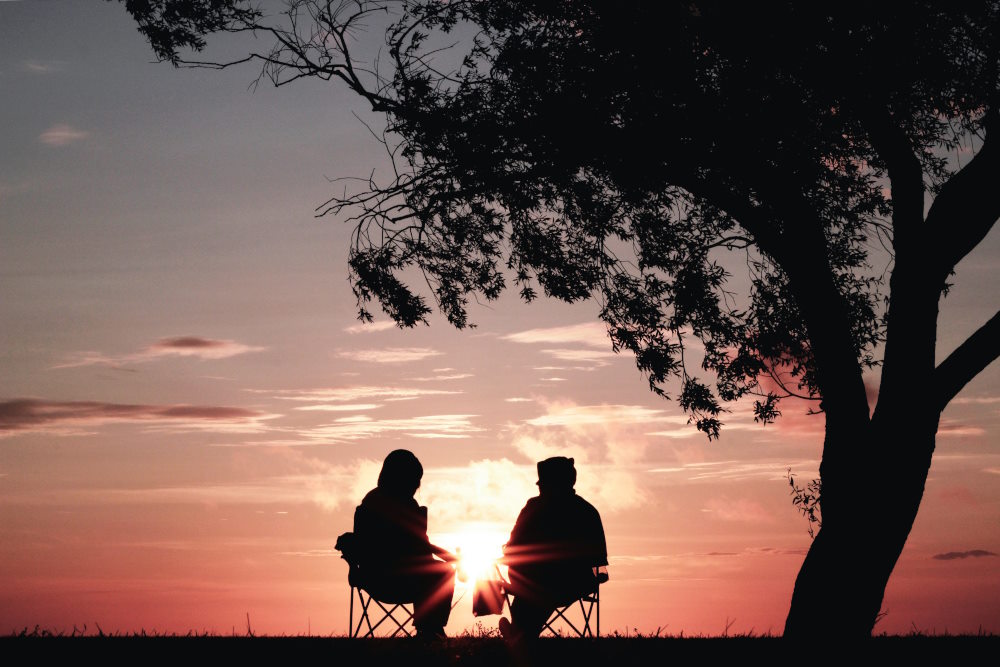 Located in the far north of New Jersey is the beautiful quaint and quiet town of Vernon. This is an image of a couple watching the sunset outside in Vernon New Jersey