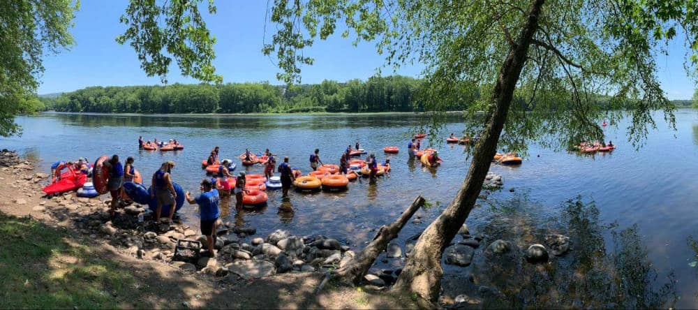 Image of a bunch of tubers getting in and out of the water at kittatinny canoes
