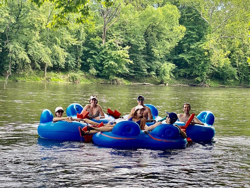 Image of six tubers roped up in a circle tubing down the Schuylkill River in PA