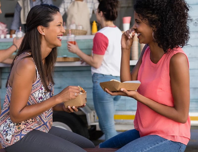 Image of two ladies eating snacks at the Colunbus Farmers Market in Columbus NJ