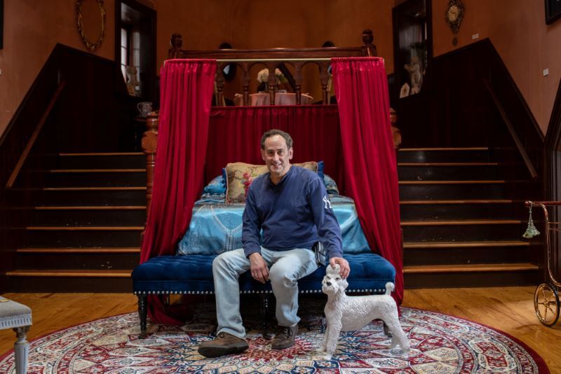 Image of a man sitting in front of the bed inside of Lucy the Elephant used for Airbnb and hotel purposes in Margate NJ