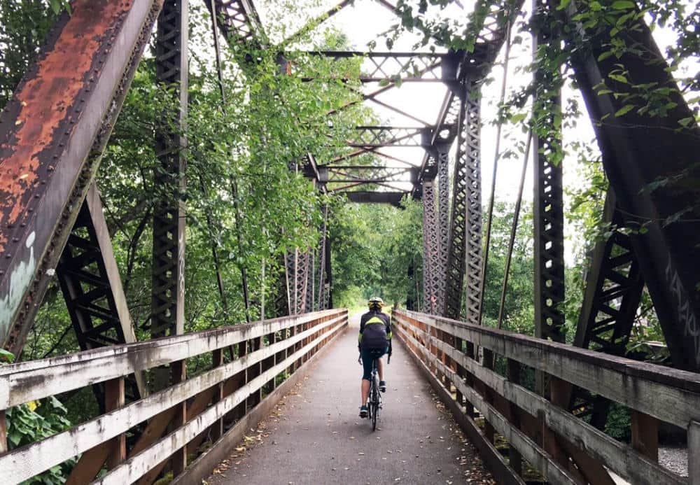 Image of a man cycling on a bridge n NJ