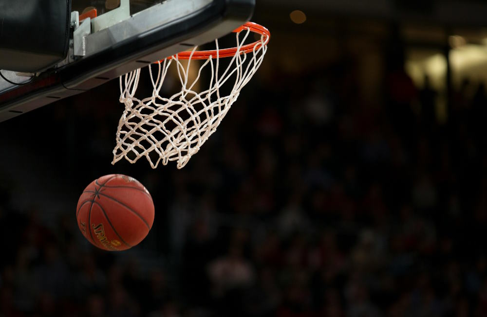 Image of a basketball going through the hoop at a Brooklyn Nets game.