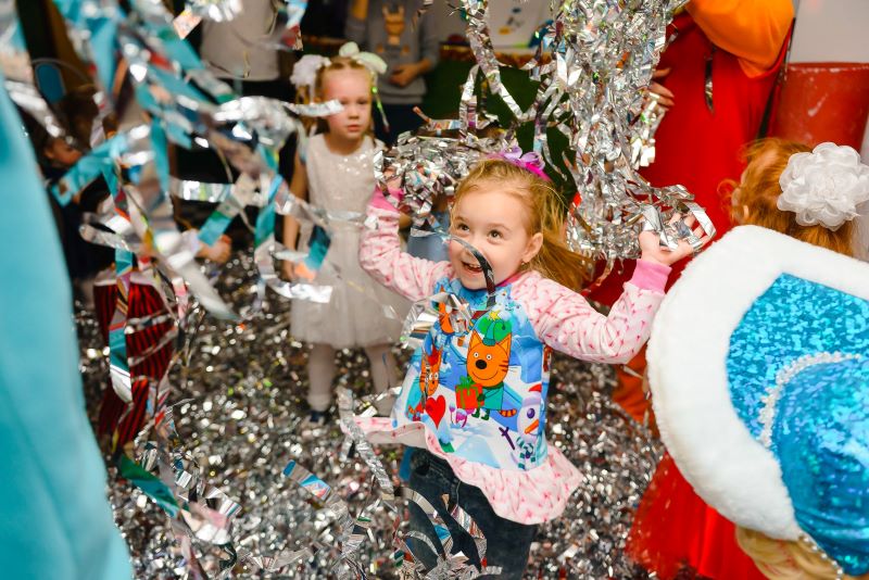 Photo of a kid at dancing among streamers at a birthday party in Southern NJ. 