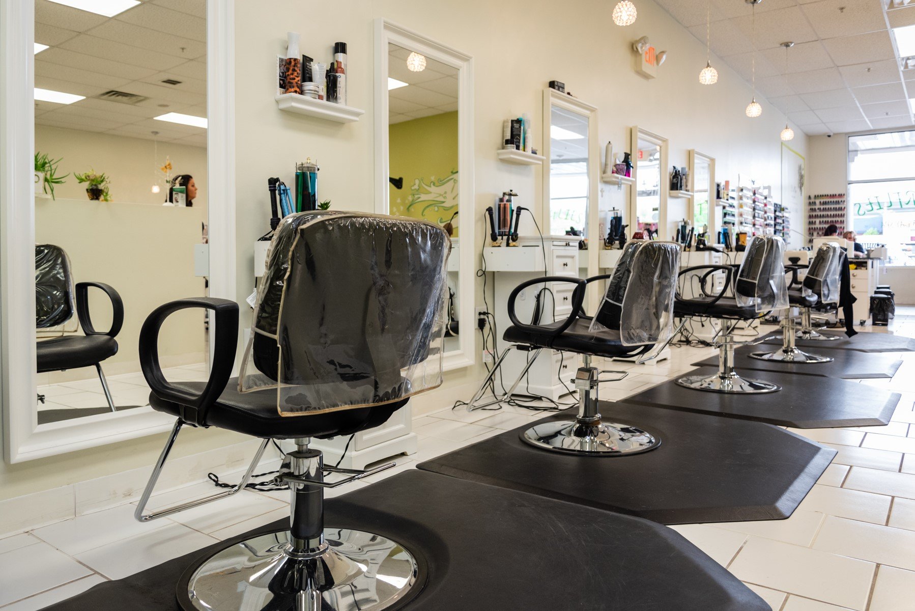 Photo of a salon with barber chairs covered with plastic and a wall of nail polish in Central, New Jersey.