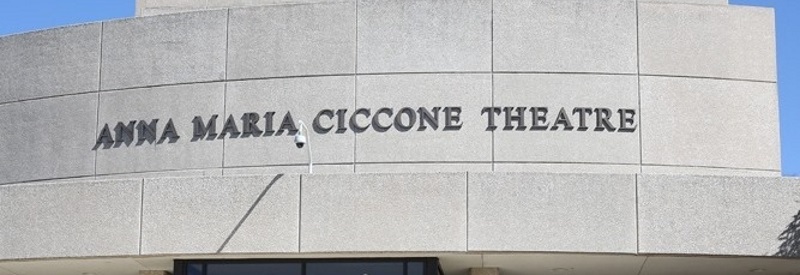 Photo of the front of The Ciccone Theater a gray building.