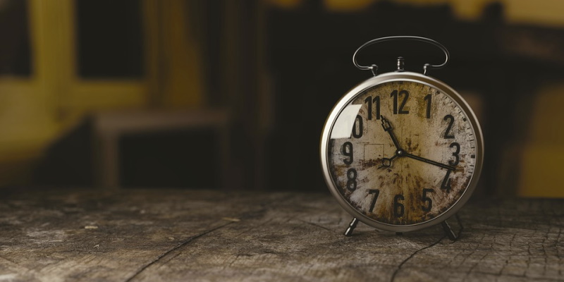 Photo of an old creepy clock on a table representing the ticking time that groups encounter while completing an escape room in NJ.