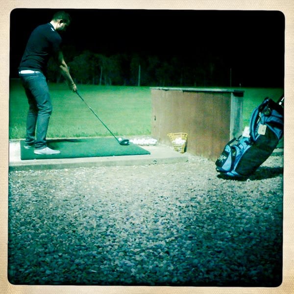 Photo of a man at a driving range at Farmer Browns Mini Golf.