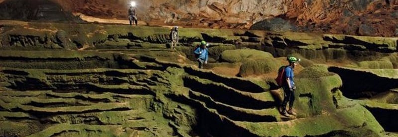 Image of the largest cave in the world with people expoloring it.