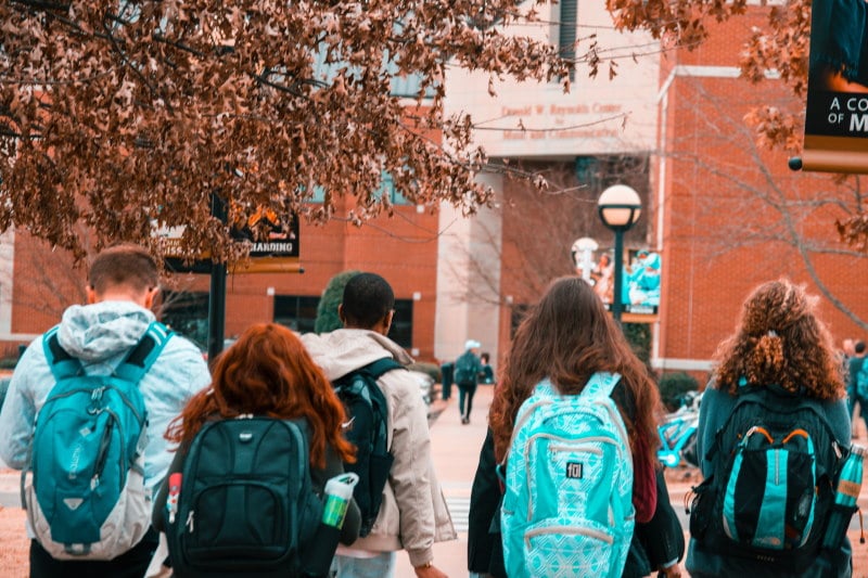 Image of students on a field trip with backpacks on 