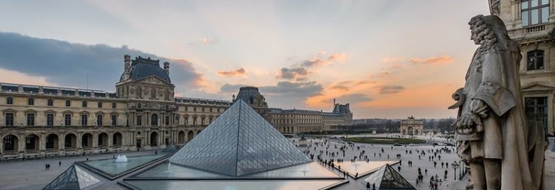 Image of the Louvre Museum in Paris France with art installments and statues.