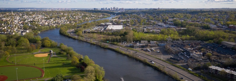 Ariel image of the River Side County Park with a baseball diamond and river running along it with cars driving on the highway