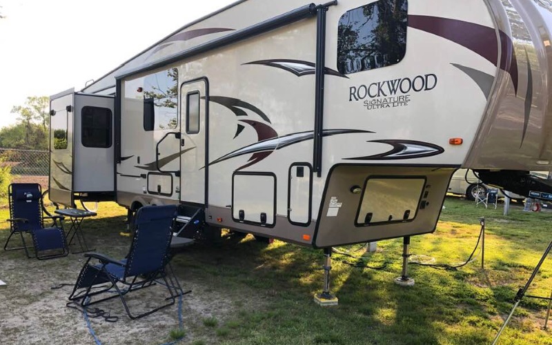 Photo of a black and white RV with its doors open at the Depot Travel Park in West Cape May, NJ