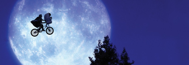 Image of a scene from the movie ET with a kid flying on a bike in front of a full moon.