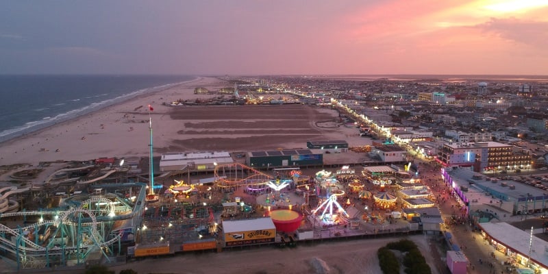 Ariel photo of Wildwood New Jersey and the famous Wildwood Boardwalk with the sun setting behind it. 