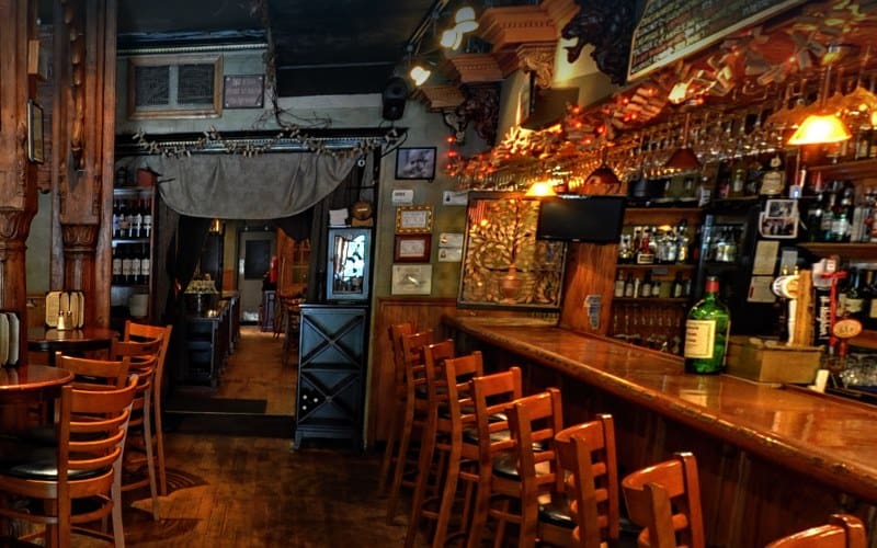 Image of a bar and dining area dimly lit