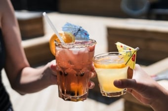 Image of two people toasting their tropical drinks showing an adult party service in NJ