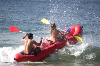 Image of two people in a raft with paddles floating through the water as an adventurous date idea in NJ