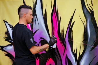 Image of an airbrush artist spray painting a wall for a child's birthday party in NJ