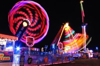 Image of amusement park rides illuminating the dark night sky as an example of a fun thing to do with kids in NJ