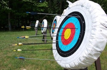 Image of arrows stuck in a target at an archery range sports center in NJ