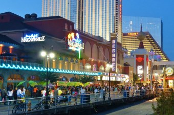 Image of the Atlantic City boardwalk lighting up at nighttime as one of New Jersey's destinations