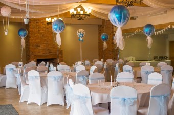 Image of tables set up with white linens and balloons showing a special occasion in NJ