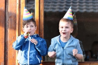 Image of two young boys wearing birthday party hats showing the best in NJ party entertainment