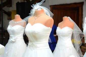 Image of three wedding dresses on mannequins at a bridal boutique as part of our NJ Wedding Guide