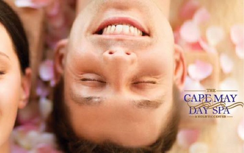 Image of a man smiling with cape may day spas logo