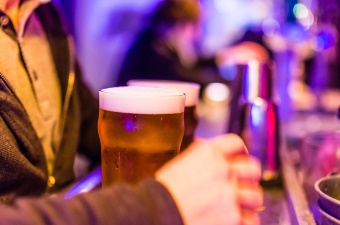 Photo of a person holding two beers at one of the best bars in the Jersey Shore