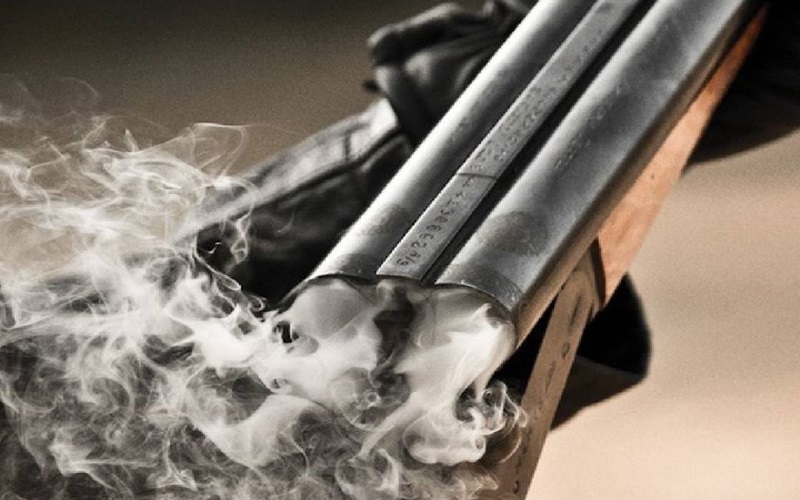 Image of a shotgun with smoke coming out of it