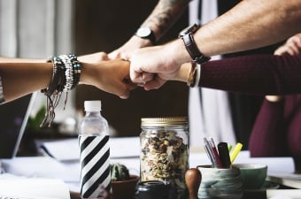 Image of people touching fists showing corporate bonding in NJ