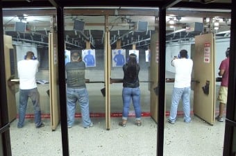 image of three people shooting guns at human paper targets at a shooting range, which looks like a really cool thing to do in NJ