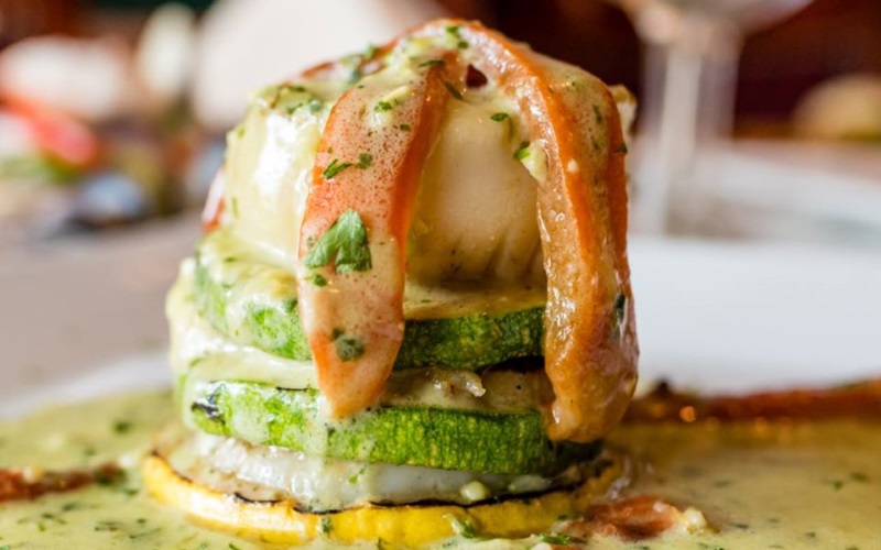 Image of a seafood dish on green zucchini 