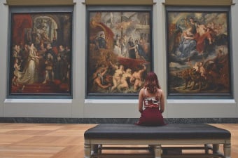 Image of a girl looking at a painting in an art gallery as part of NJ arts and culture