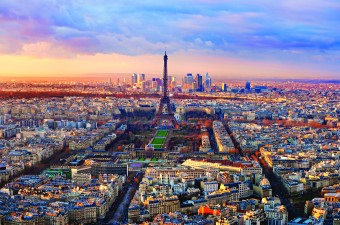 A long shot aerial image landscape of the Eiffel Tower in the middle of the city Paris France.