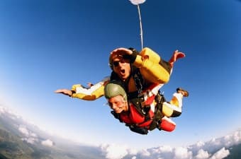 a man parasailing with an instructer