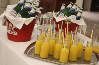 Image of glass bottles of orange juice on a tray at a special occasion in NJ